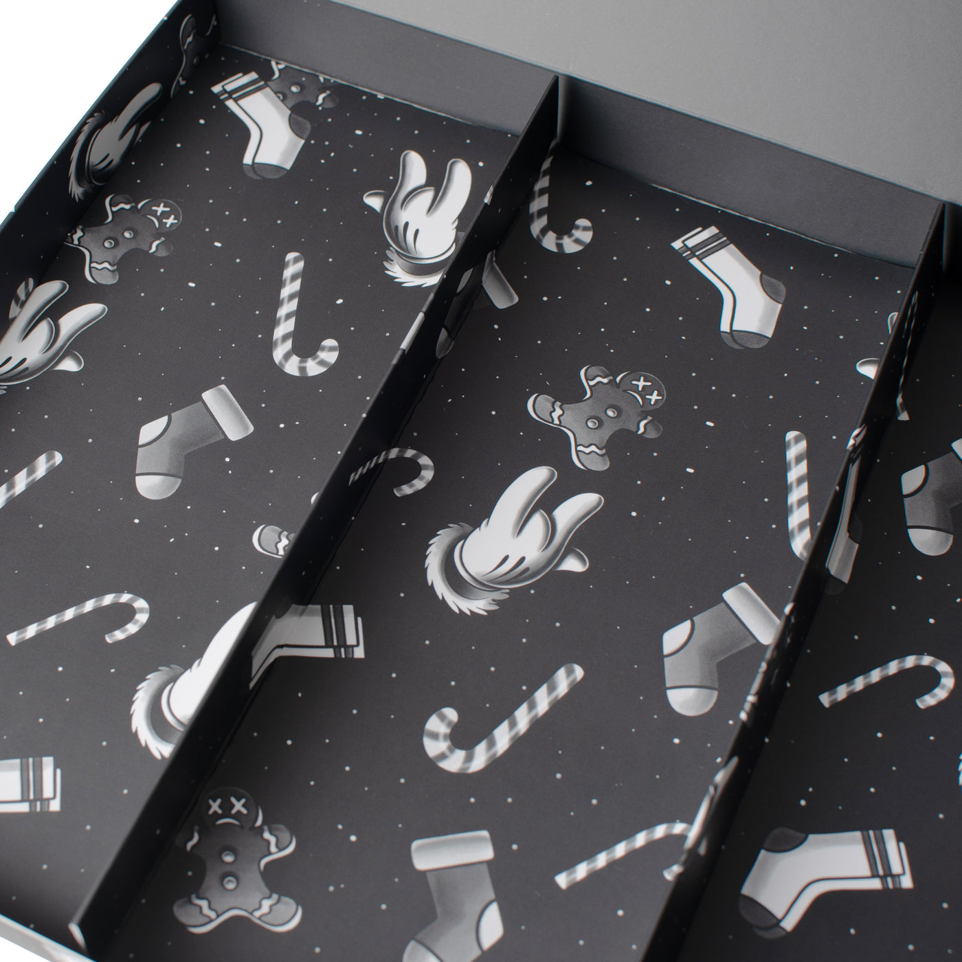 Close up of empty interior of Christmas giftbox with candy cane and gingerbread man illustrations by american socks