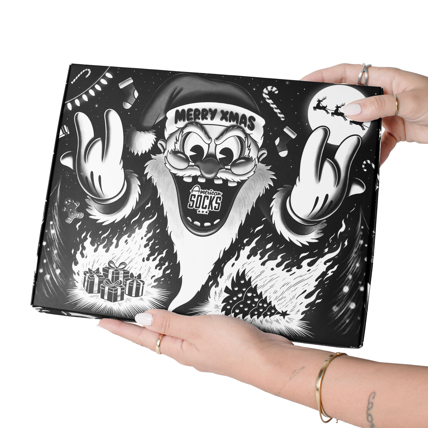 Hands holding merry Xmas Giftbox by american socks
