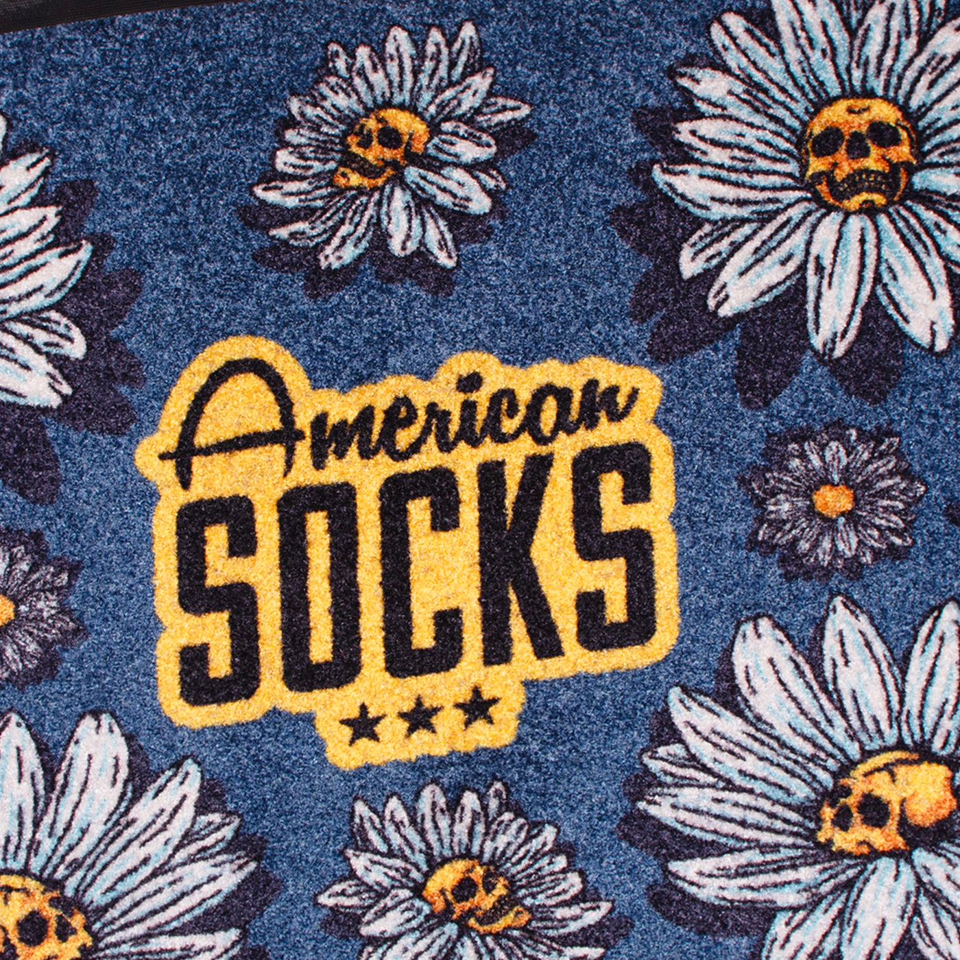Close up of american socks logo on floral patterned rug with alternative daisy flowers with skulls in the middle design 